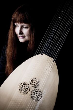 Promotional picture of Christina Pluhar, showing her with her instrument